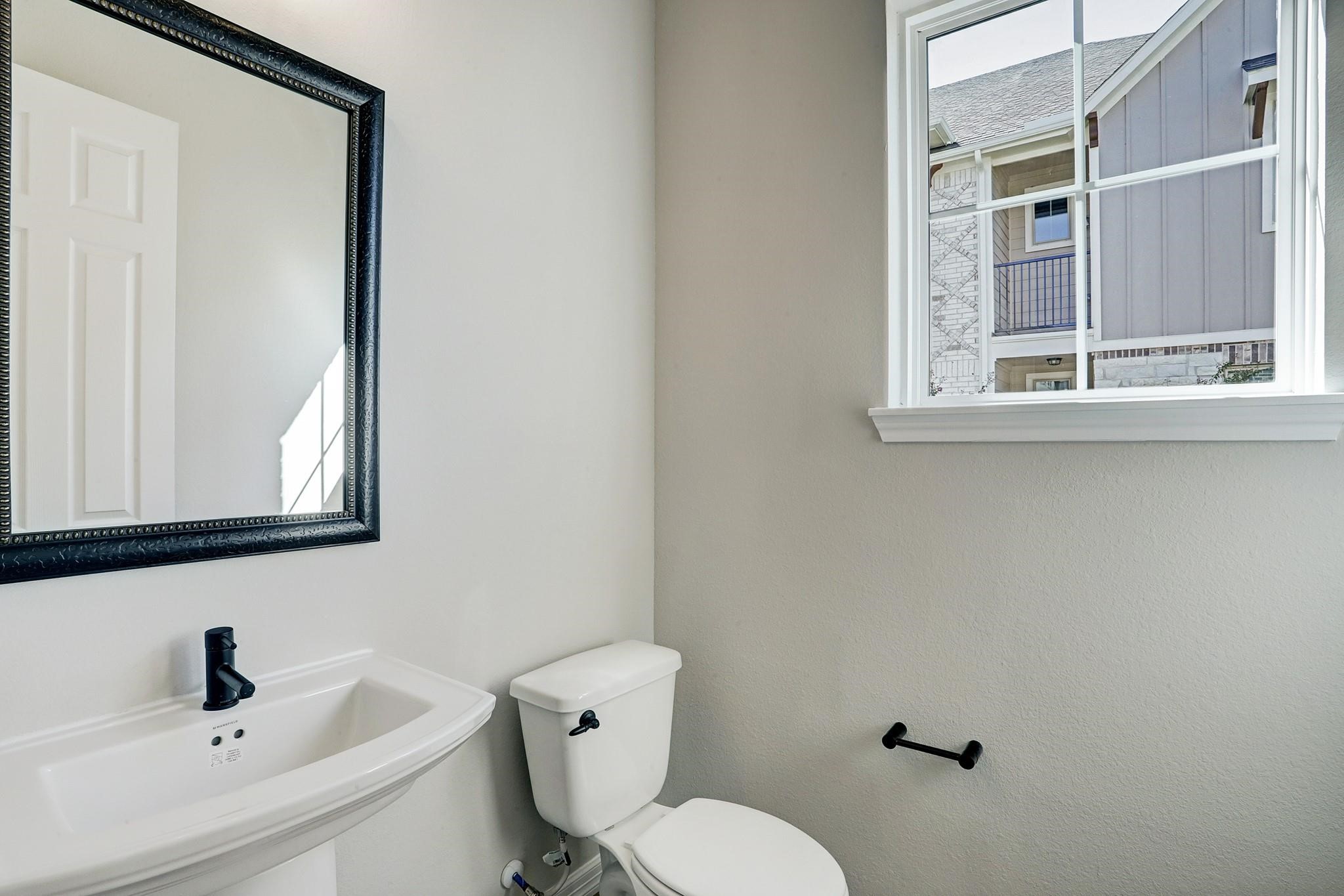 9522 Caddo Ridge Lane Cypress, TX 77433 - Photo 13 of 38 a bathroom with a sink mirror and toilet
