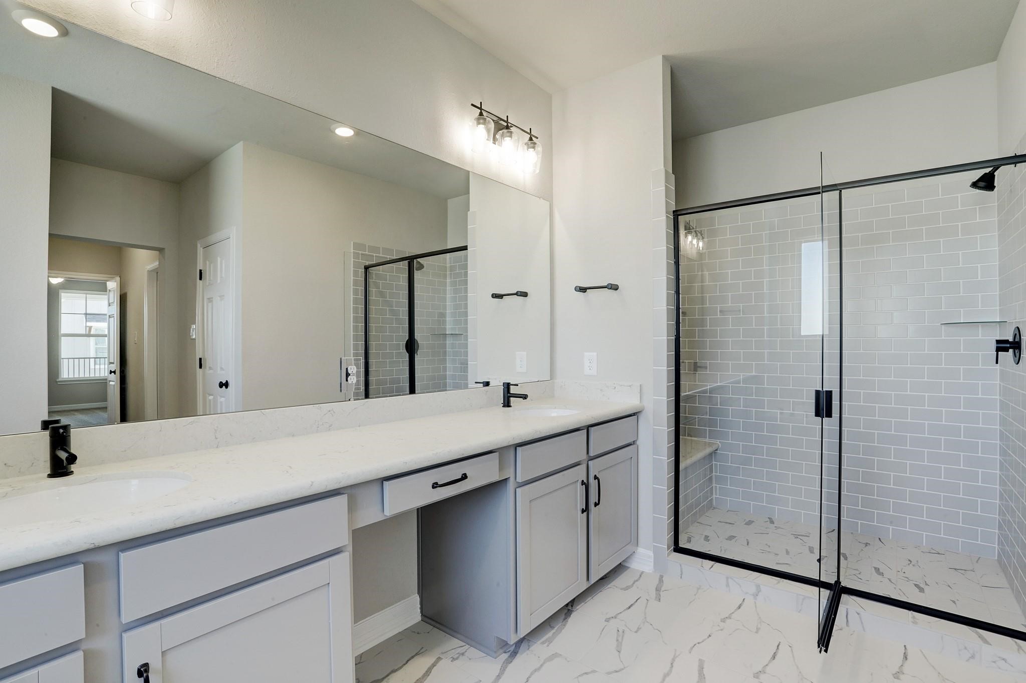 9522 Caddo Ridge Lane Cypress, TX 77433 - Photo 19 of 38 a bathroom with a double vanity sink mirror and shower