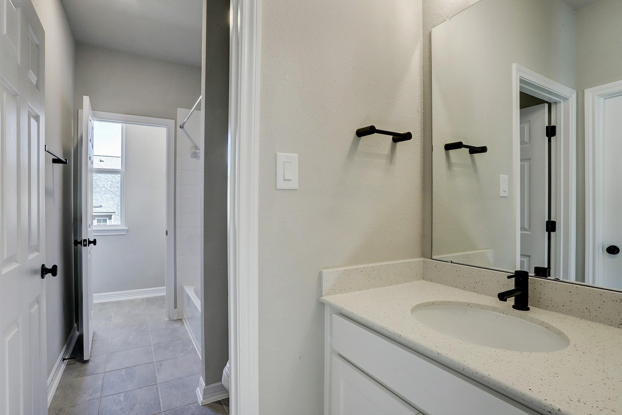 9522 Caddo Ridge Lane Cypress, TX 77433 - Photo 22 of 38 a bathroom with a sink and a mirror