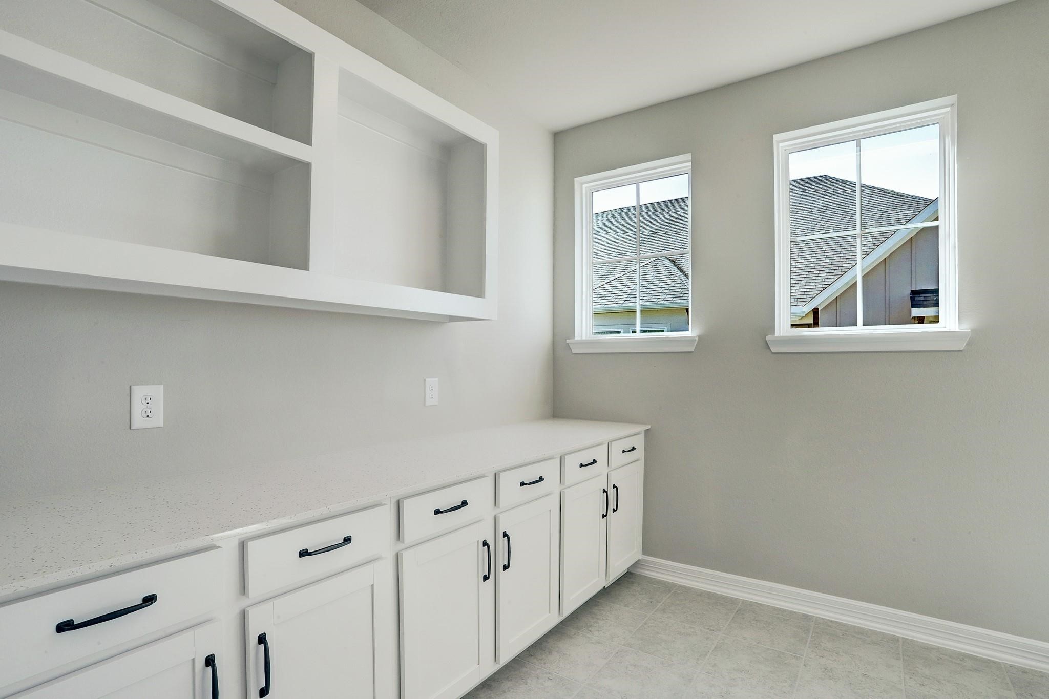 9522 Caddo Ridge Lane Cypress, TX 77433 - Photo 26 of 38 a kitchen with white cabinets and window