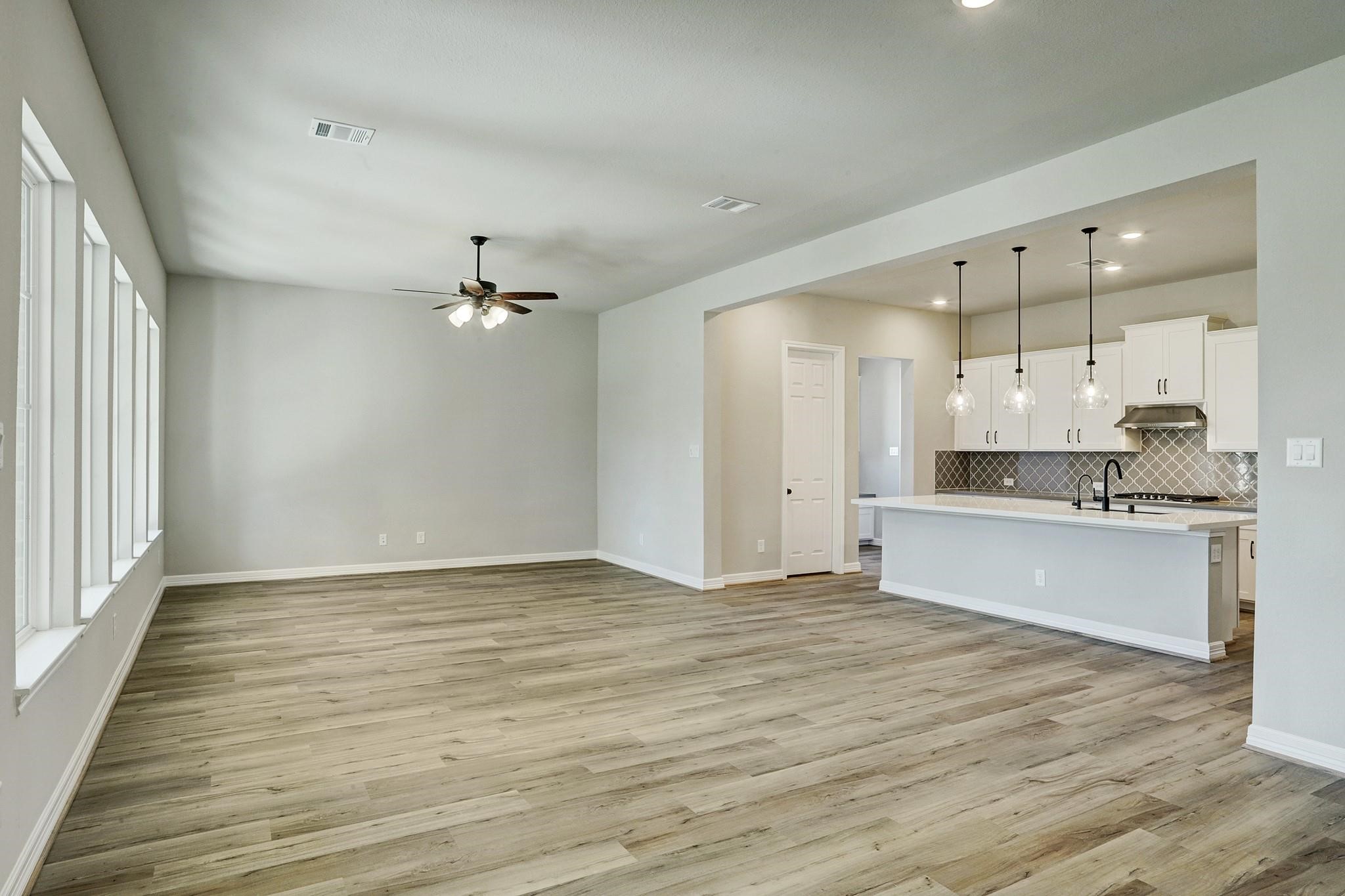 9522 Caddo Ridge Lane Cypress, TX 77433 - Photo 5 of 38 a view of a kitchen with marble kitchen and kitchen with wooden floor