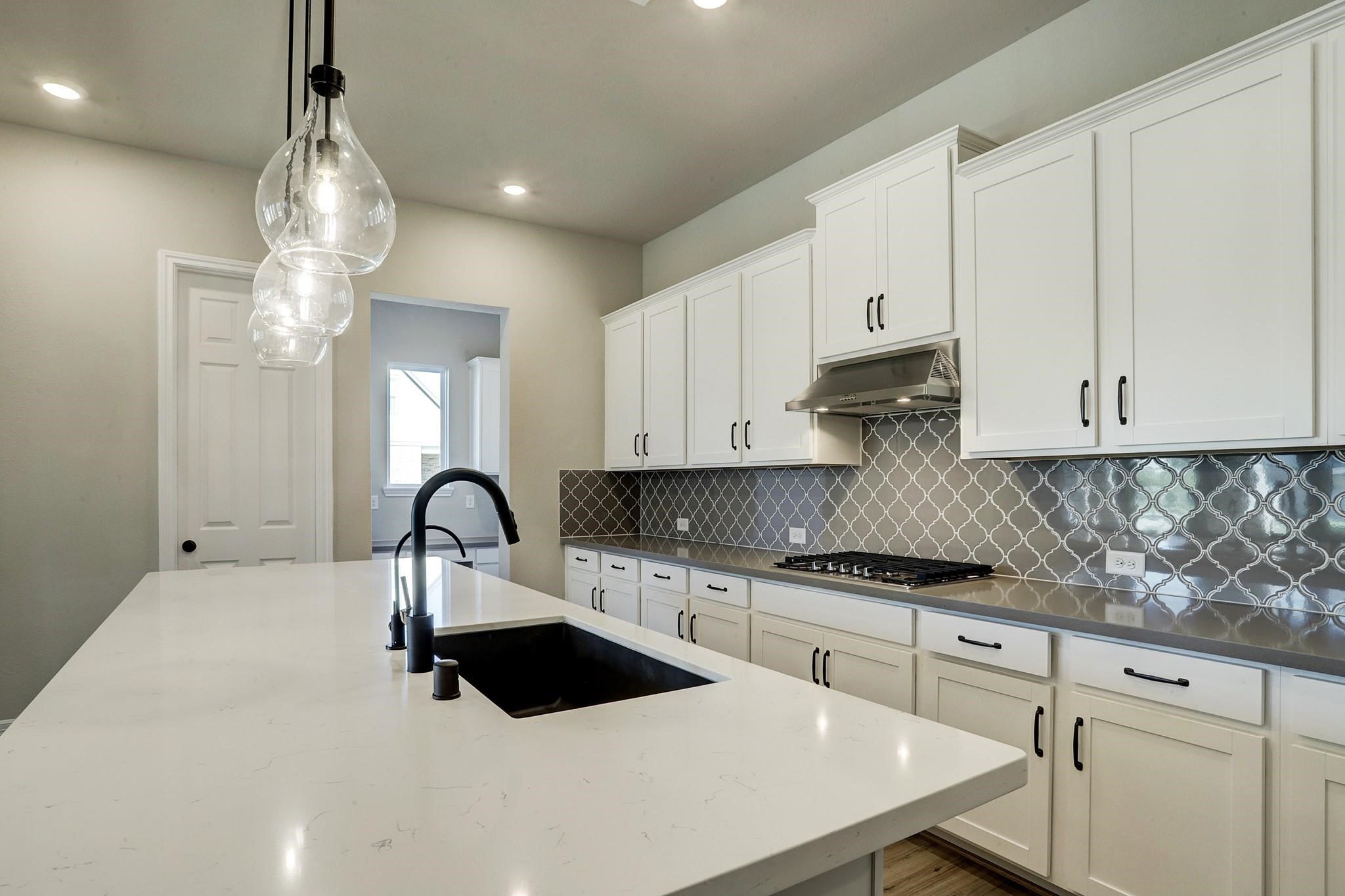 9522 Caddo Ridge Lane Cypress, TX 77433 - Photo 7 of 38 a kitchen with kitchen island granite countertop a white stove top oven and cabinets