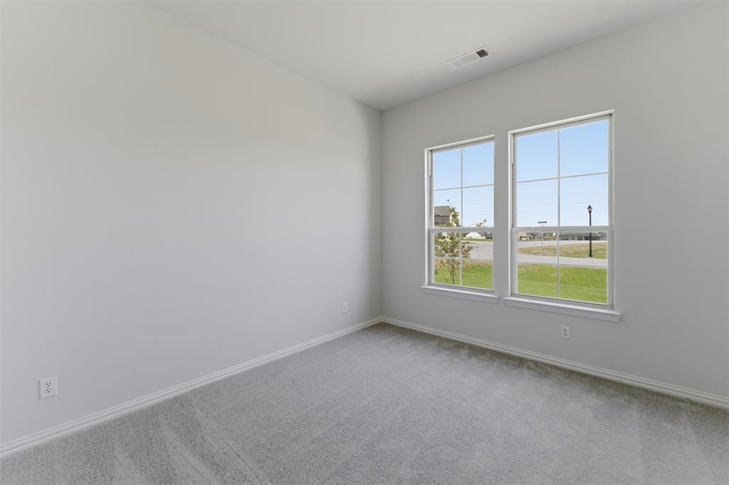 104 Snowy Owl Trail Rhome, TX 76078 - Photo 7 of 27 Room featuring light gray carpet, white baseboards, and neutral wall paint