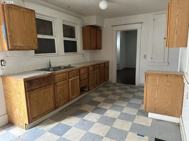 a kitchen with stainless steel appliances granite countertop a sink and a cabinets