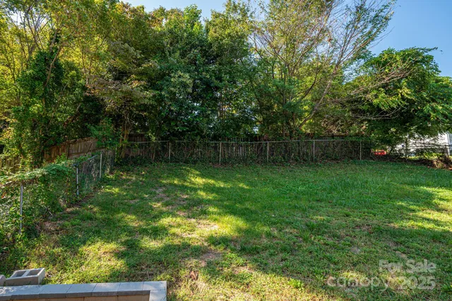 a kitchen with granite countertop cabinets stainless steel appliances and a sink