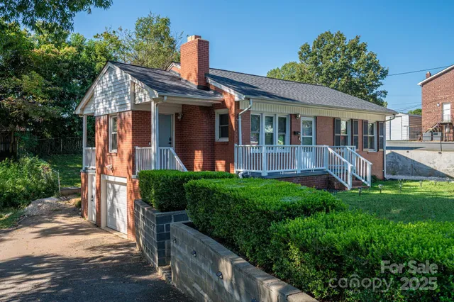 a front view of a house with a yard and porch