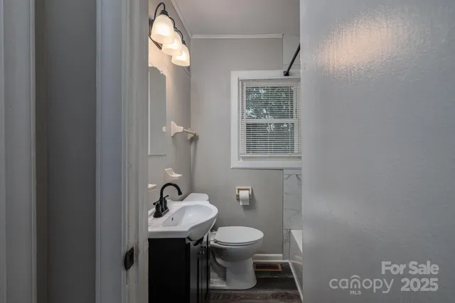 a view of an empty room and wooden floor