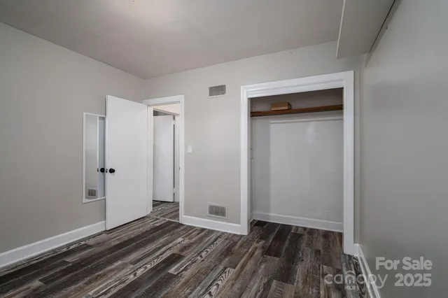 a view of a room with wooden floor and window