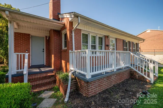 a view of a brick house with a large window