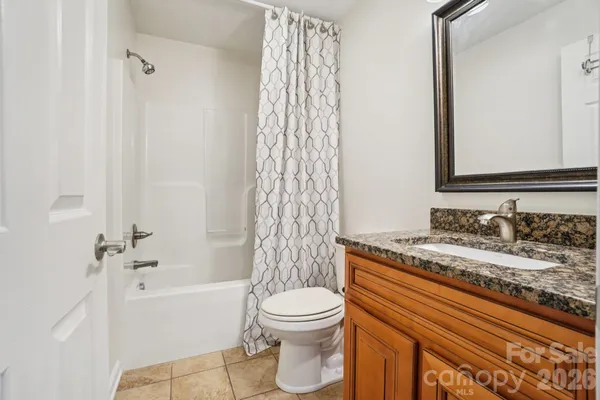 a bathroom with a granite countertop sink toilet a shower and a bathtub