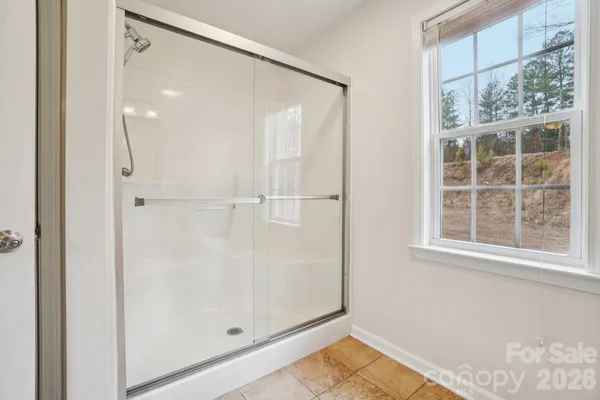 a view of a bathroom with a glass shower door