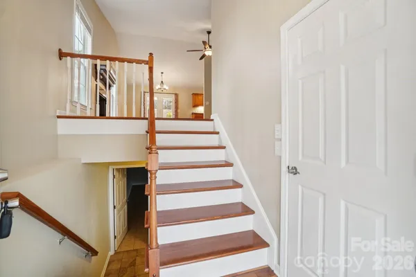a view of staircase with white walls and a window