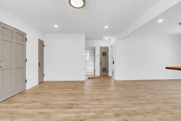 a view of an empty room with wooden floor