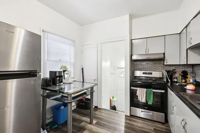 a kitchen with stainless steel appliances granite countertop a refrigerator stove and sink