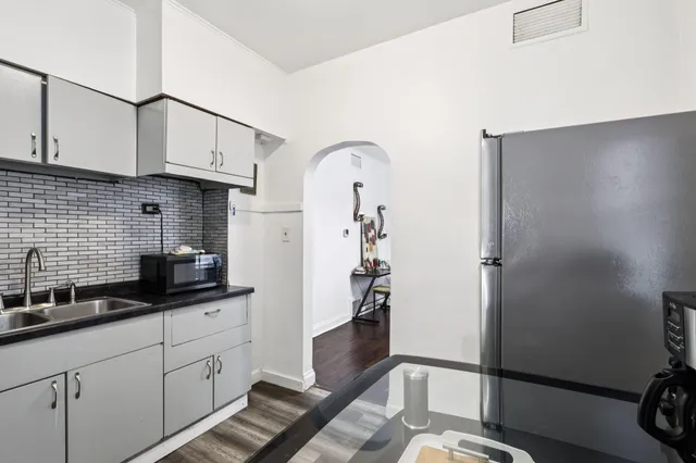 a kitchen with sink and cabinets