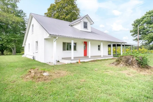 a view of a house with a yard and plants