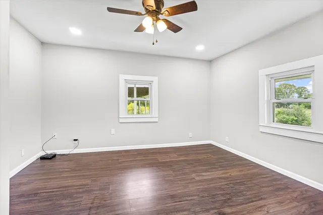 wooden floor in an empty room with a window