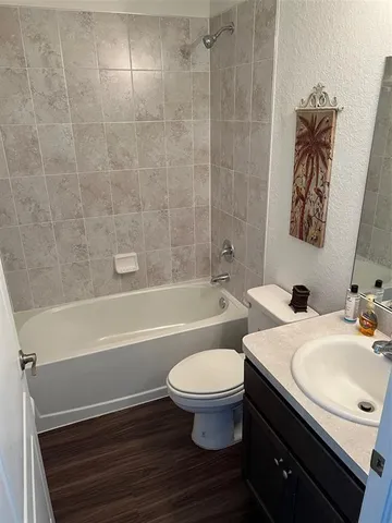 a bathroom with a sink a toilet and a bathtub