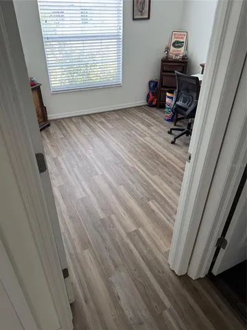 a view of a hardwood floor and closet