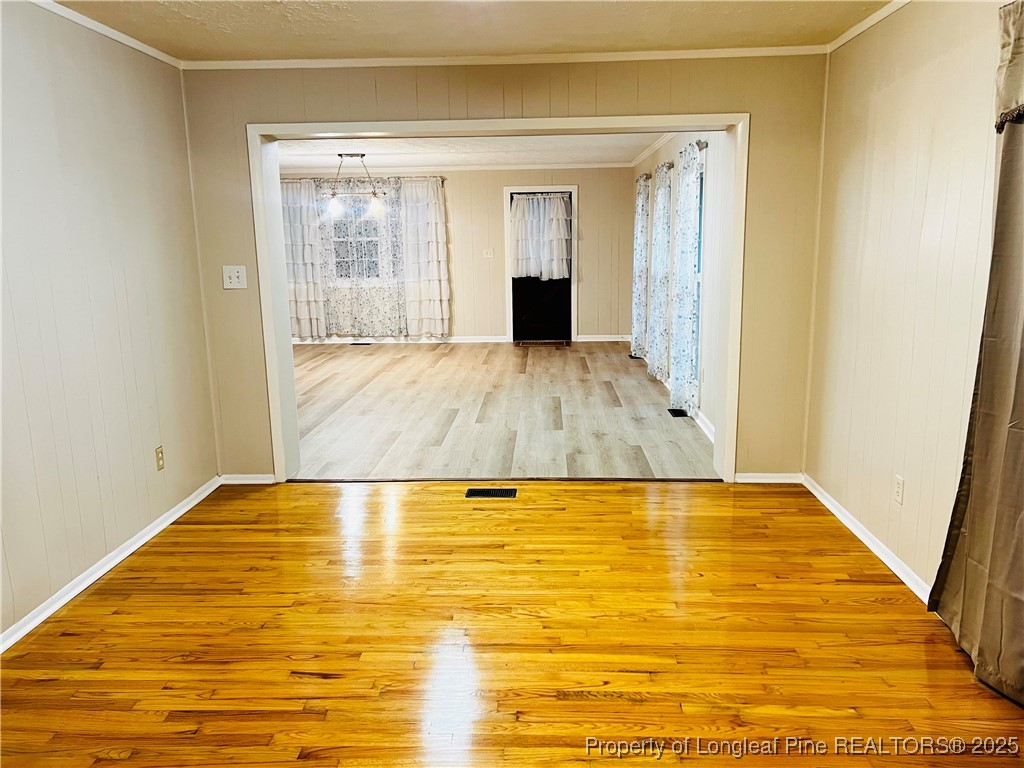 10481 Bostic Road Laurinburg, NC 28352 - Photo 3 of 15 a view of empty room with wooden floor and fan