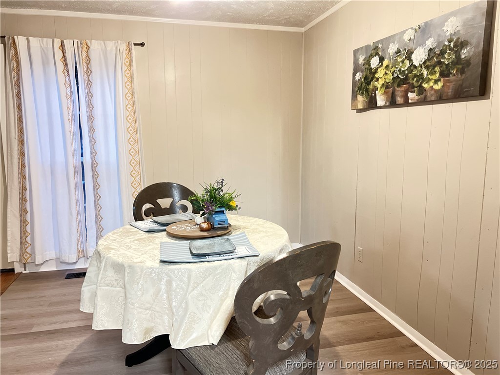 10481 Bostic Road Laurinburg, NC 28352 - Photo 5 of 15 a dining room with furniture and wooden floor