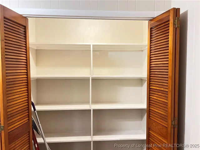 a view of closet area with empty racks