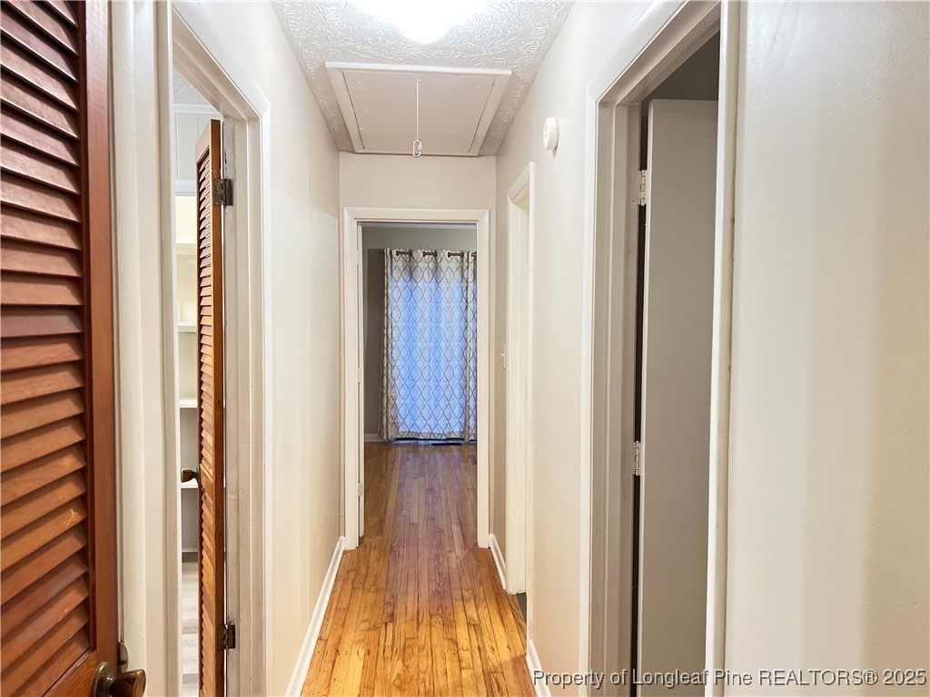 10481 Bostic Road Laurinburg, NC 28352 - Photo 8 of 15 a view of a hallway with wooden floor and staircase