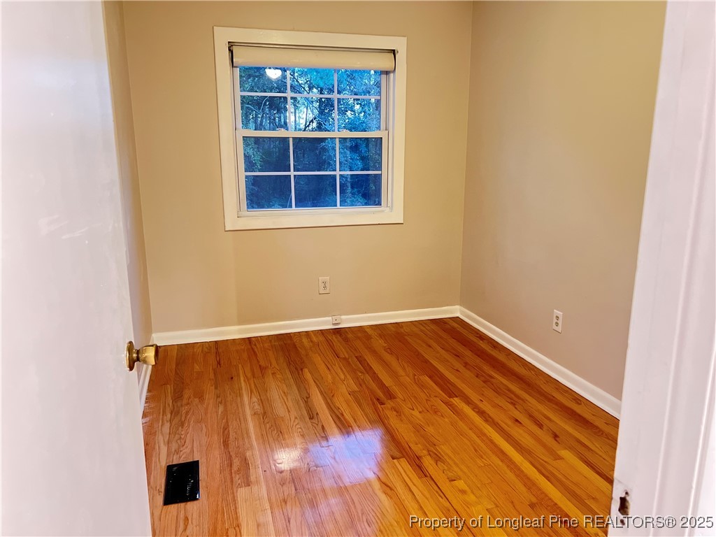 10481 Bostic Road Laurinburg, NC 28352 - Photo 9 of 15 a view of an empty room with wooden floor and a window