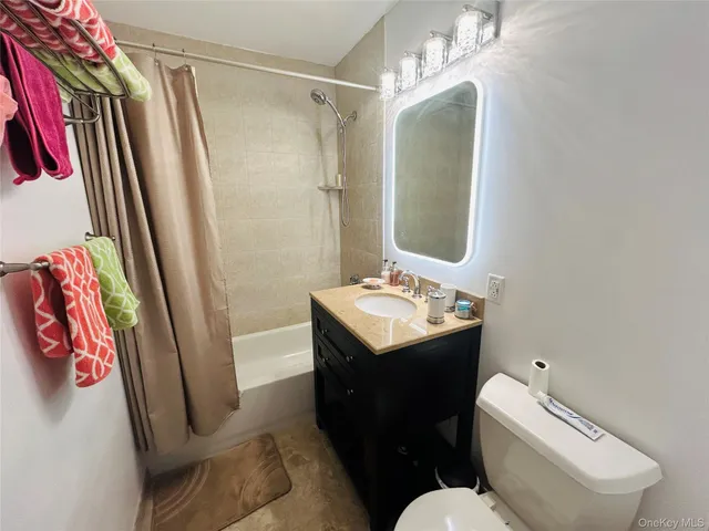 a bathroom with a sink vanity mirror and toilet