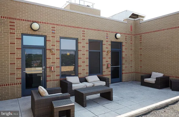 a view of a patio with couches table and chairs and potted plants