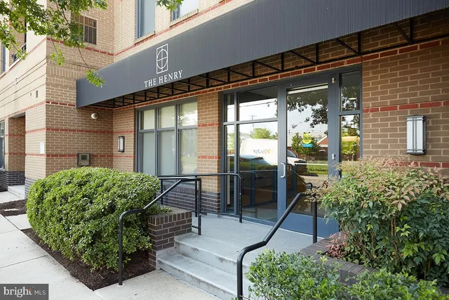 a backyard of a house with outdoor seating and plants