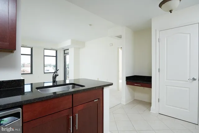 a kitchen with a sink and a wooden cabinets
