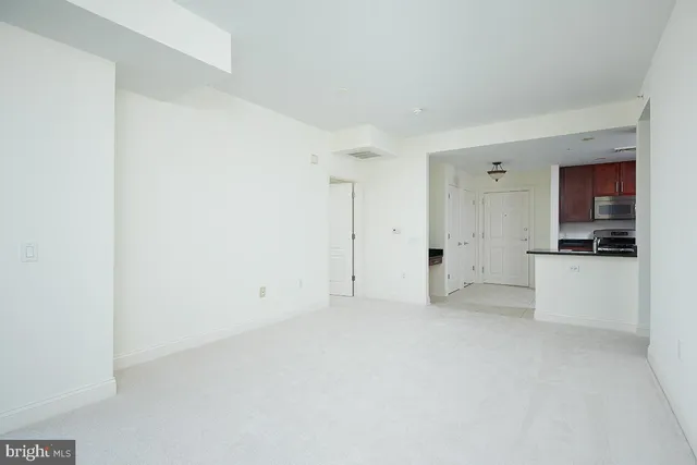 a view of a kitchen with white cabinets