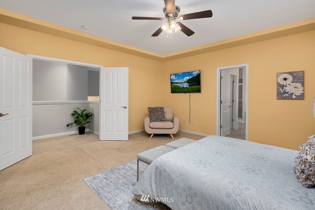 22214 151st Place Southeast Monroe, WA 98272 - Photo 22 of 28 a bedroom with a bed and a chandelier
