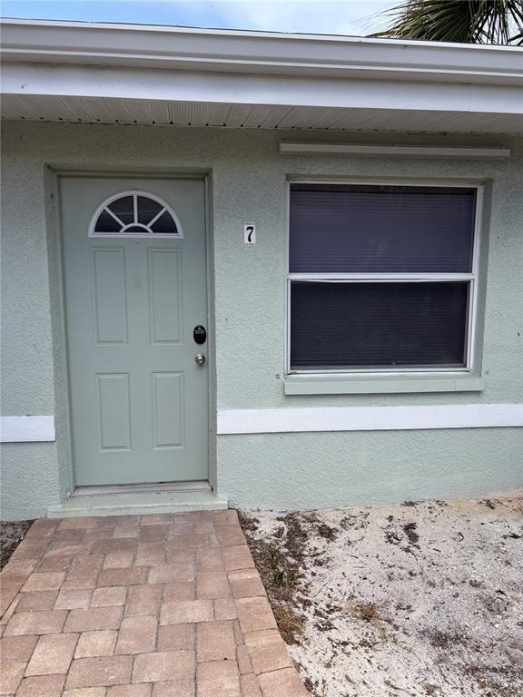 9030 Blind Pass Road, Unit C7 St. Petersburg, FL 33706 - Photo 4 of 16 a view of a wooden door