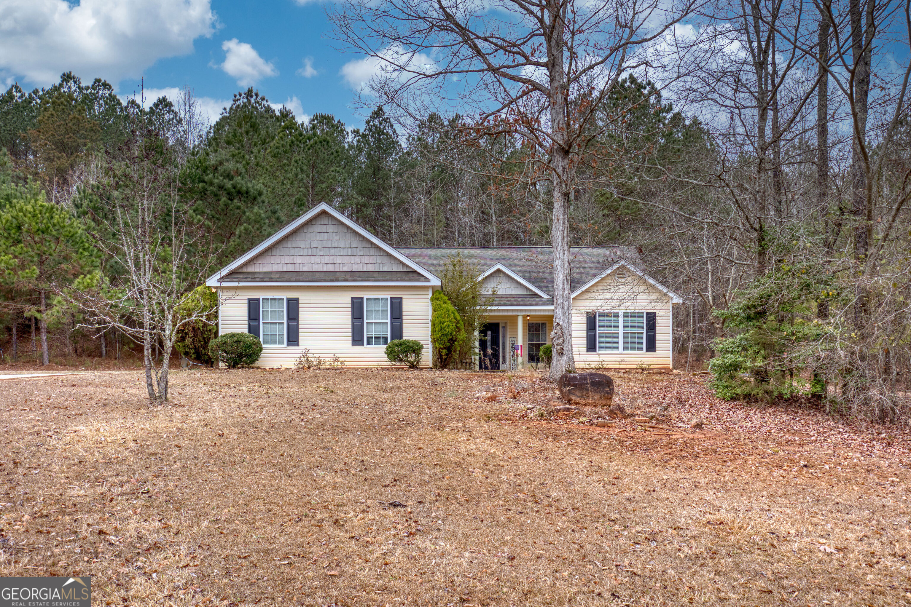 119 Cedar Ridge Drive LaGrange, GA 30241 - Photo 1 of 34 a front view of a house with a yard covered in snow