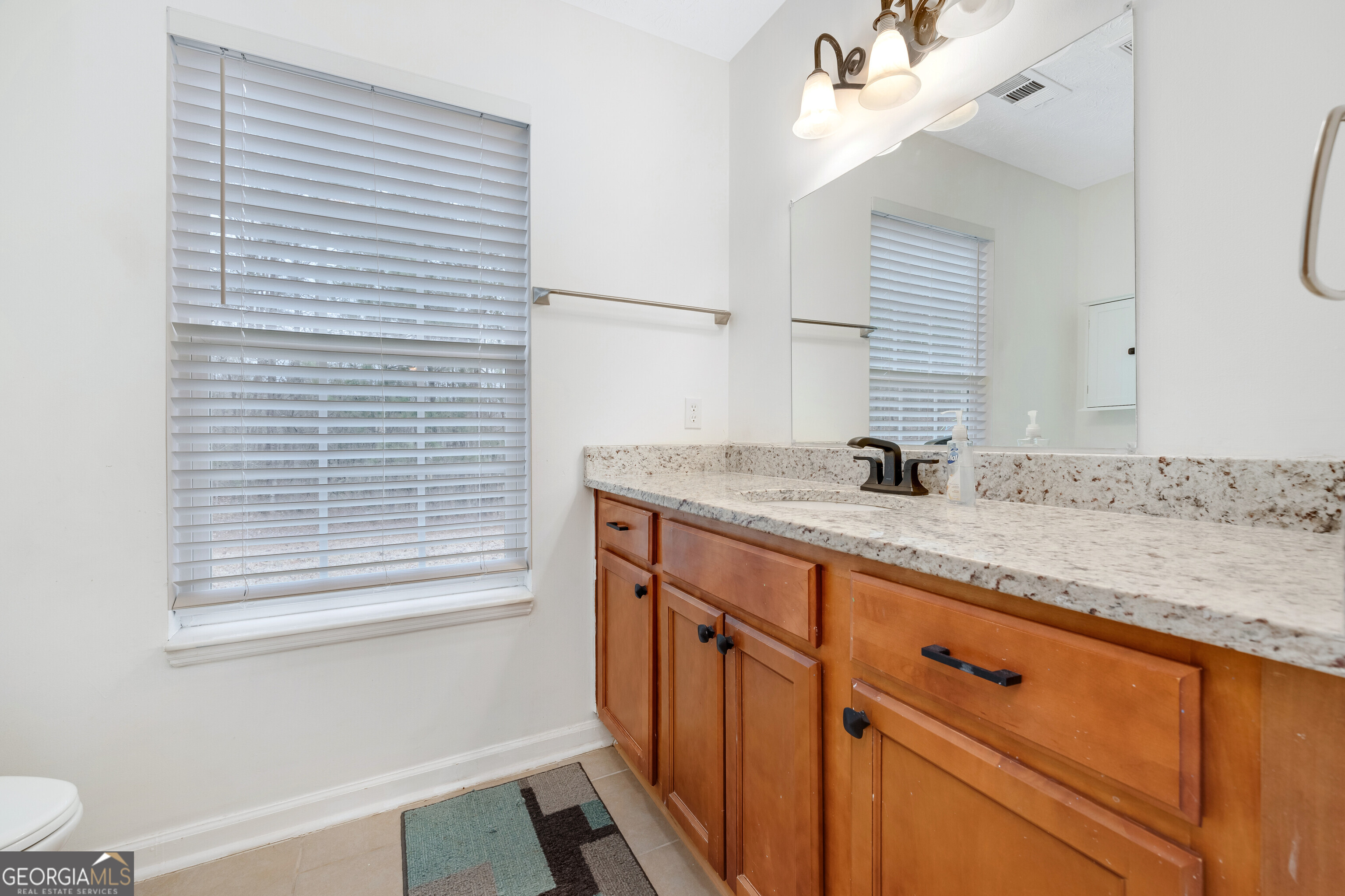 119 Cedar Ridge Drive LaGrange, GA 30241 - Photo 16 of 34 a bathroom with a granite countertop sink and a mirror