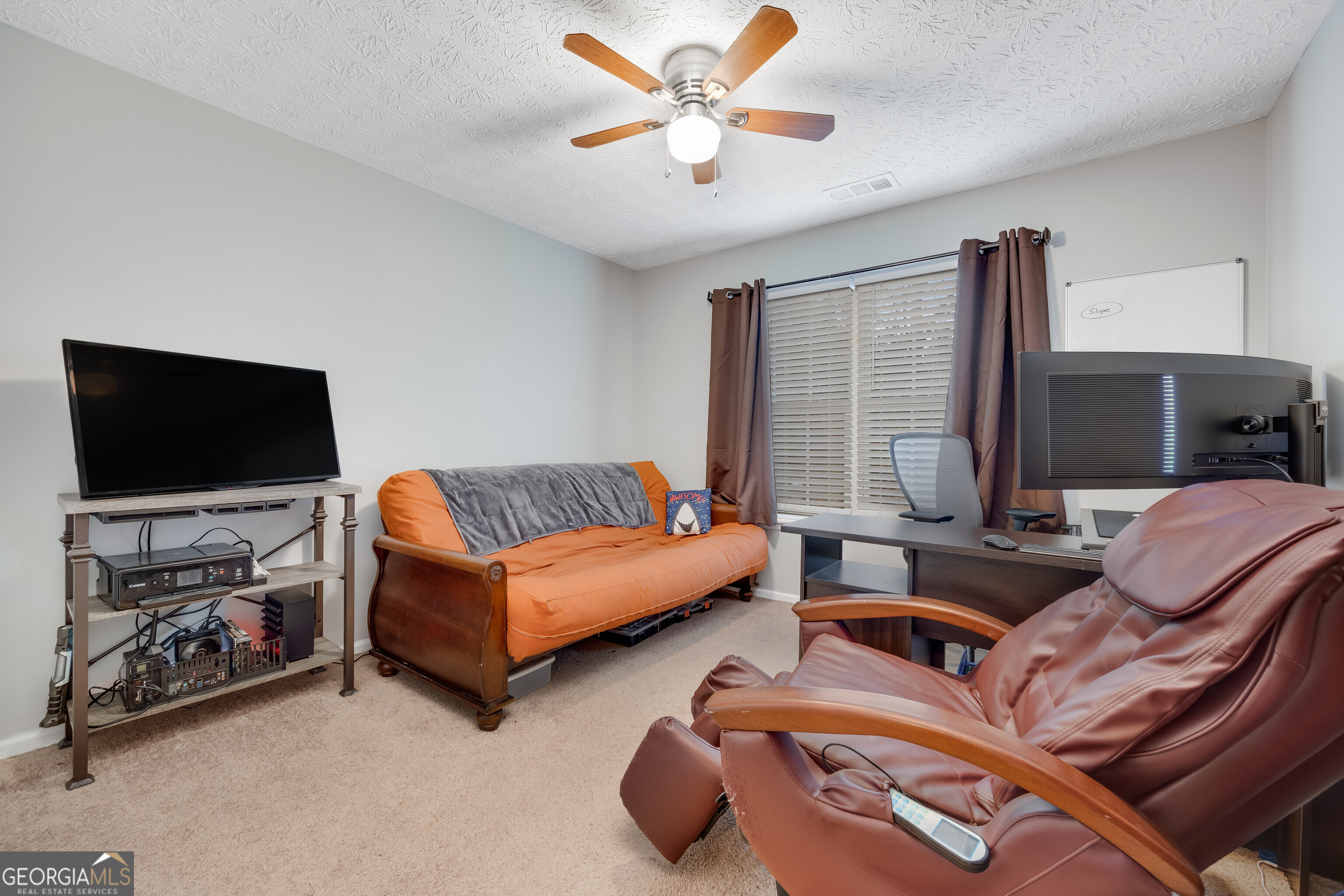 119 Cedar Ridge Drive LaGrange, GA 30241 - Photo 18 of 34 a living room with furniture and a flat screen tv