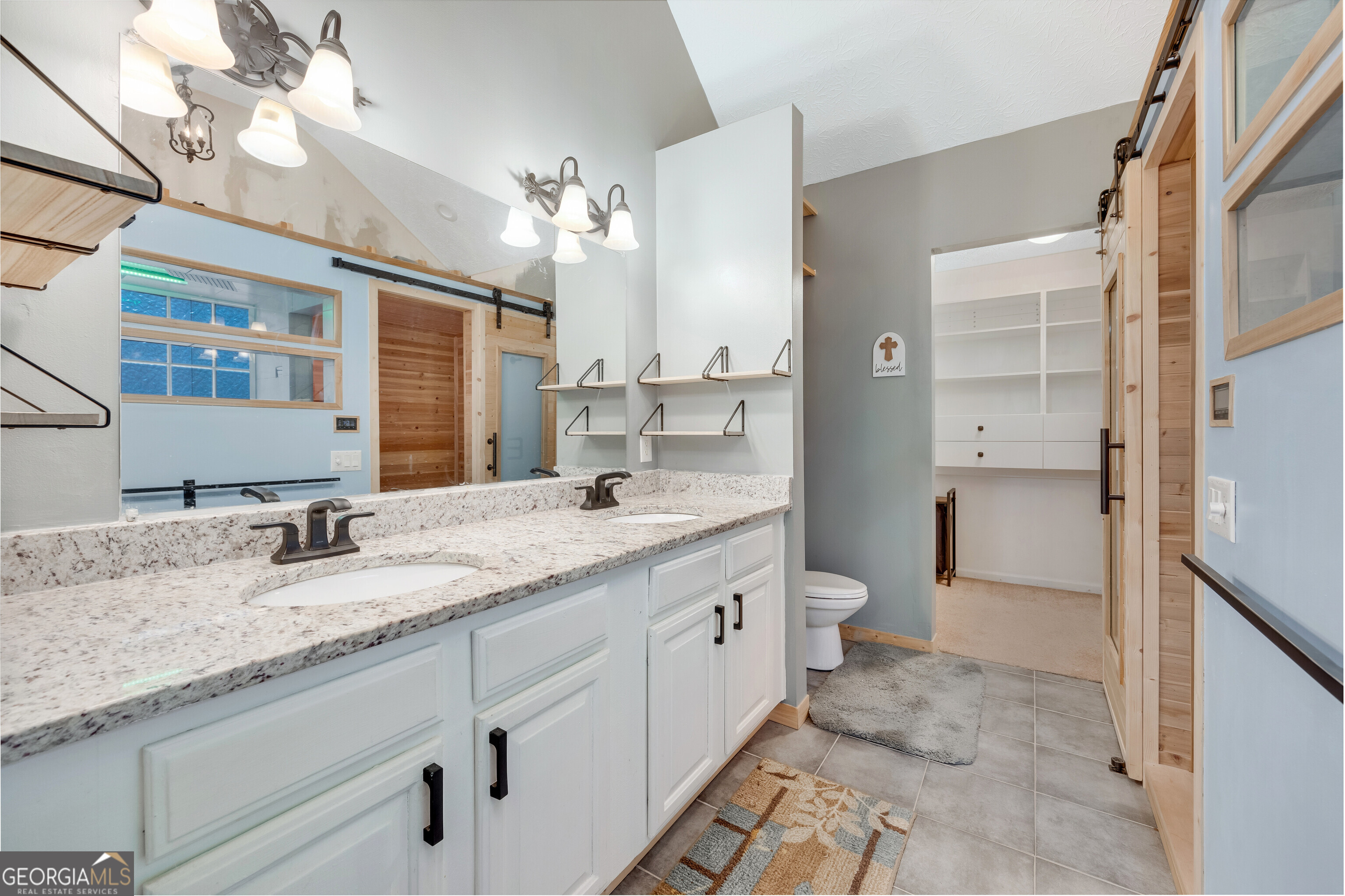 119 Cedar Ridge Drive LaGrange, GA 30241 - Photo 24 of 34 a bathroom with a granite countertop double vanity sink a mirror and a toilet