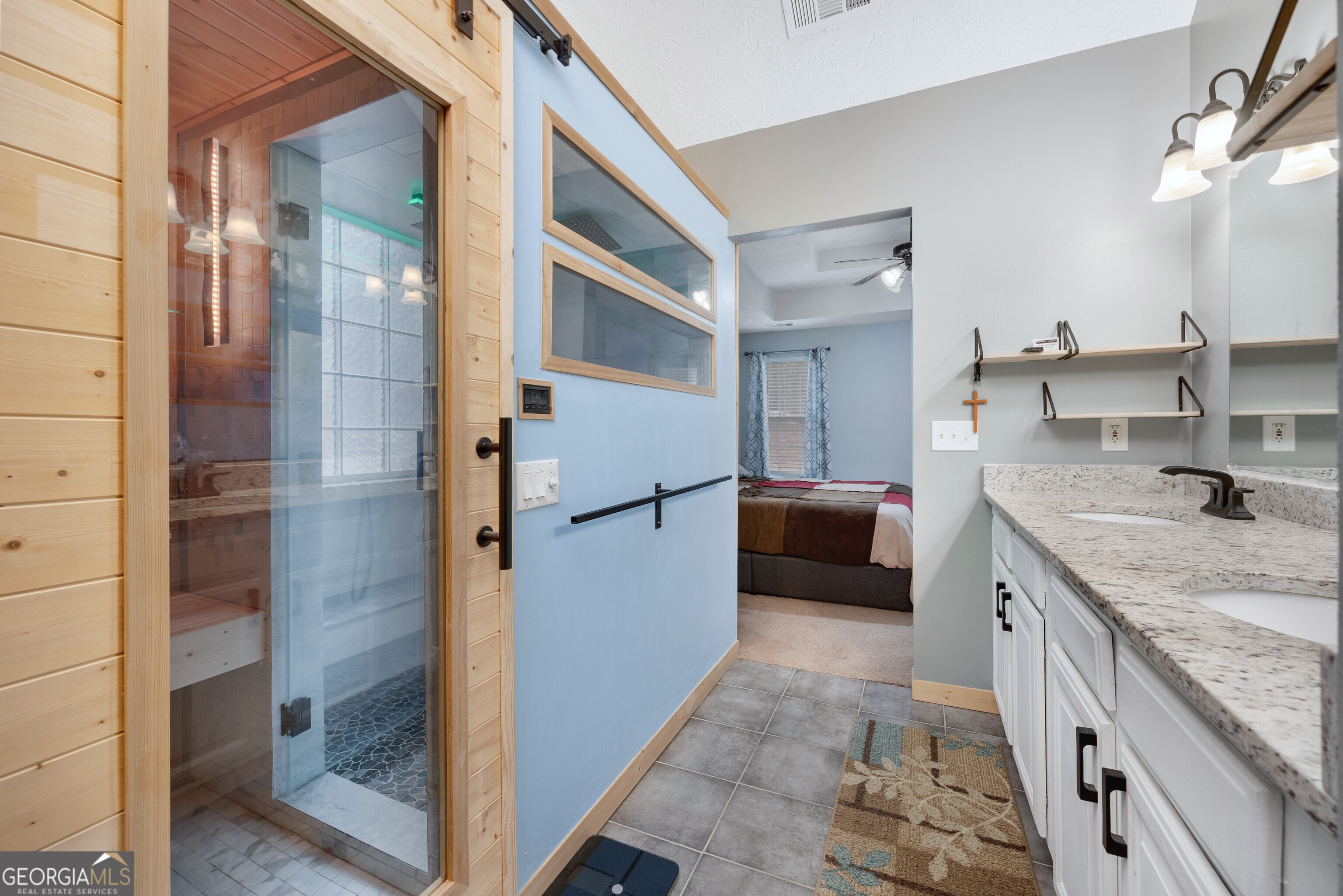119 Cedar Ridge Drive LaGrange, GA 30241 - Photo 25 of 34 a bathroom with a granite countertop sink a mirror and shower