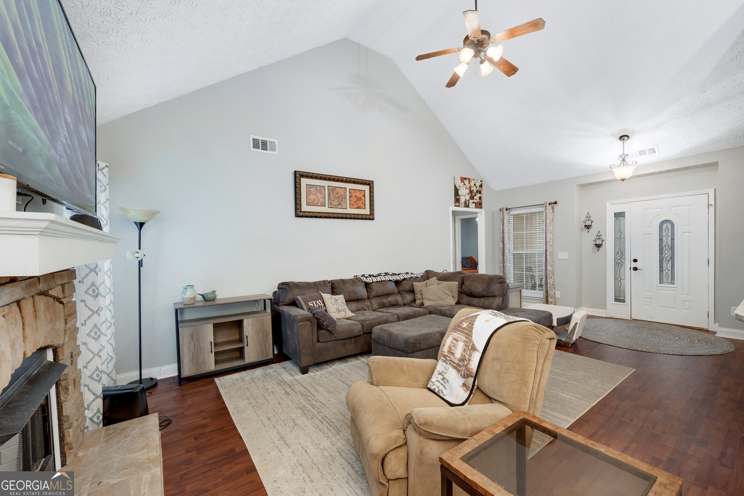 119 Cedar Ridge Drive LaGrange, GA 30241 - Photo 8 of 34 a living room with fireplace furniture and a wooden floor