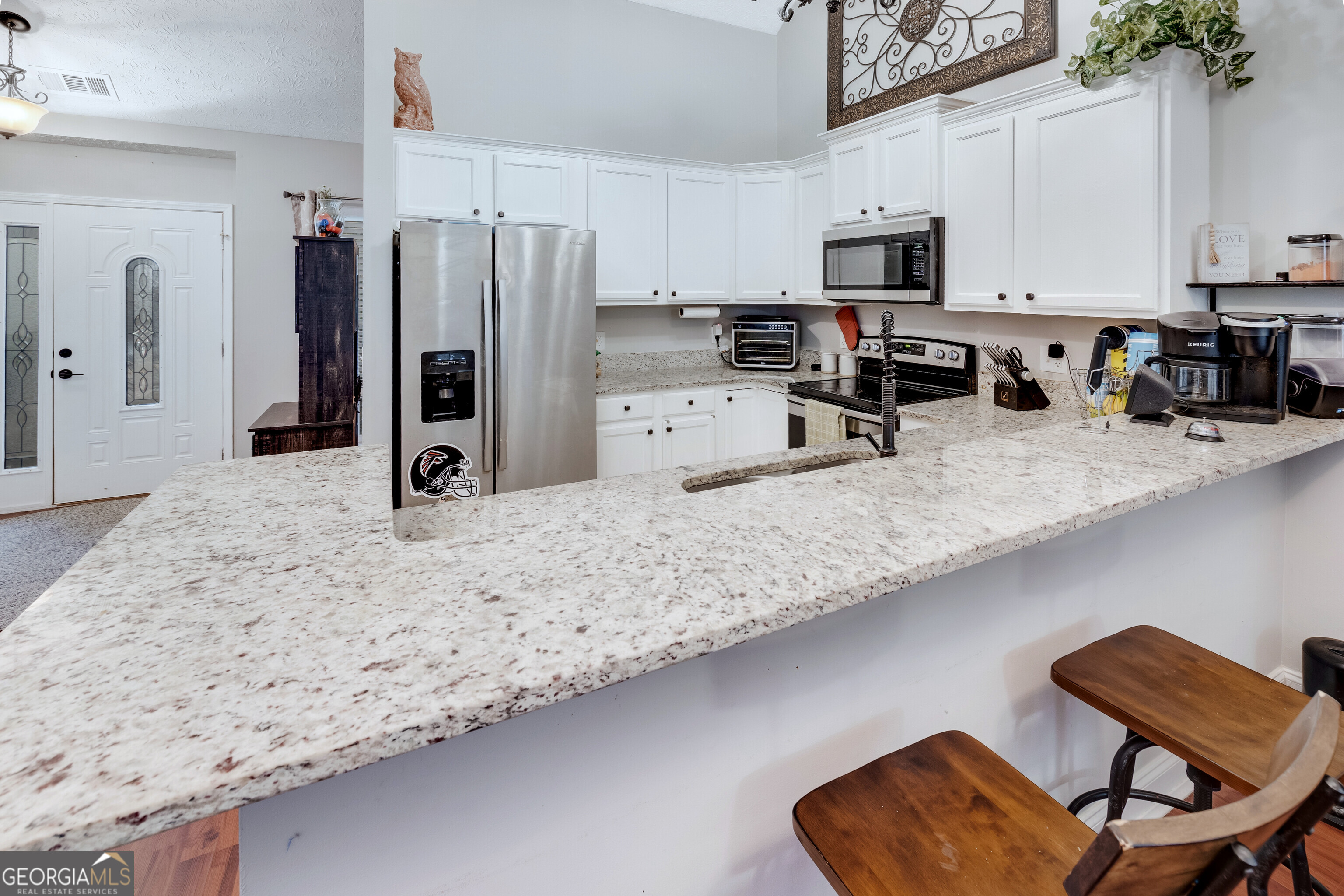 119 Cedar Ridge Drive LaGrange, GA 30241 - Photo 9 of 34 a kitchen with stainless steel appliances granite countertop a refrigerator a stove a sink a microwave and a refrigerator