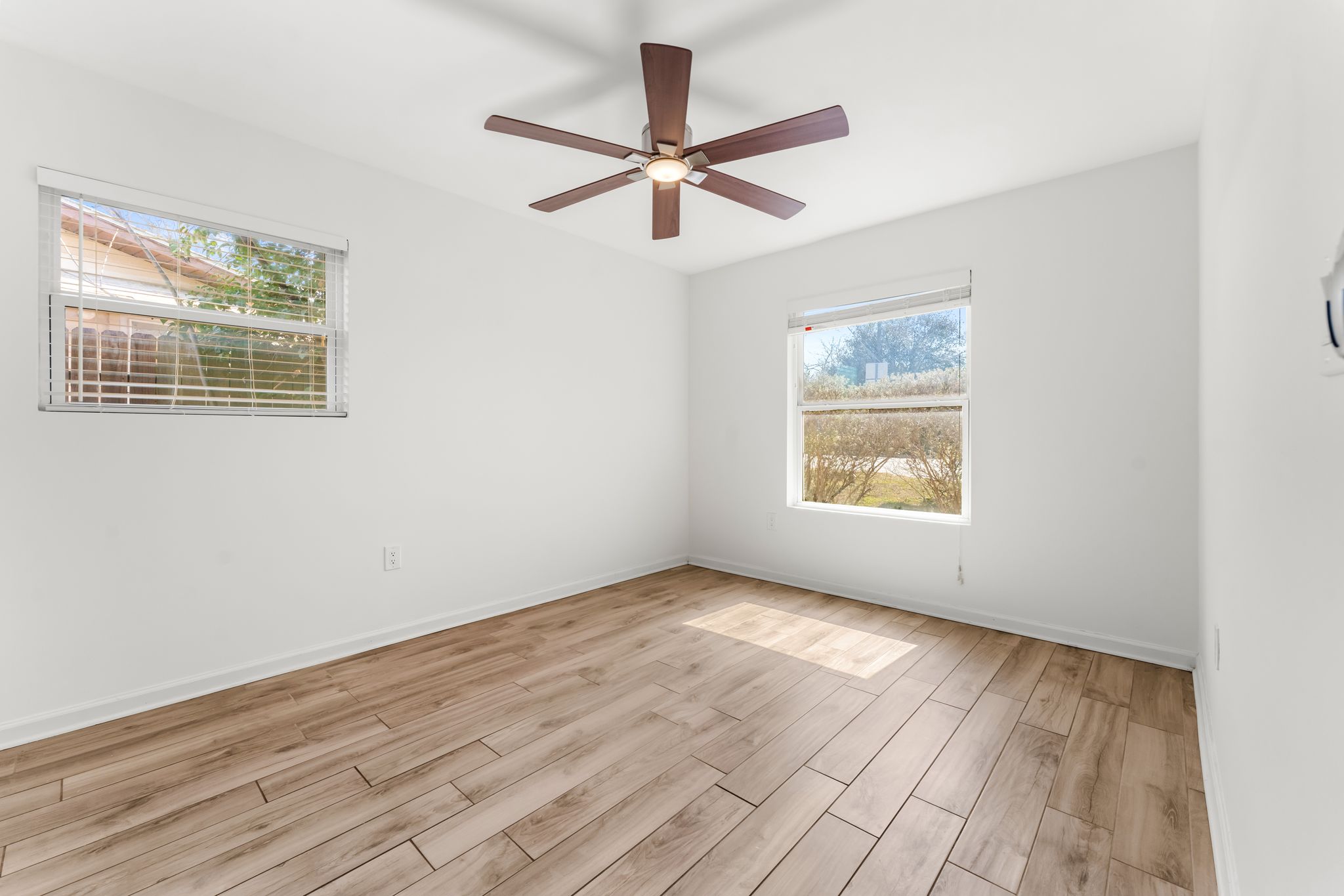 1900 Ohlen Road Austin, TX 78757 - Photo 20 of 34 a view of an empty room with wooden floor and a window