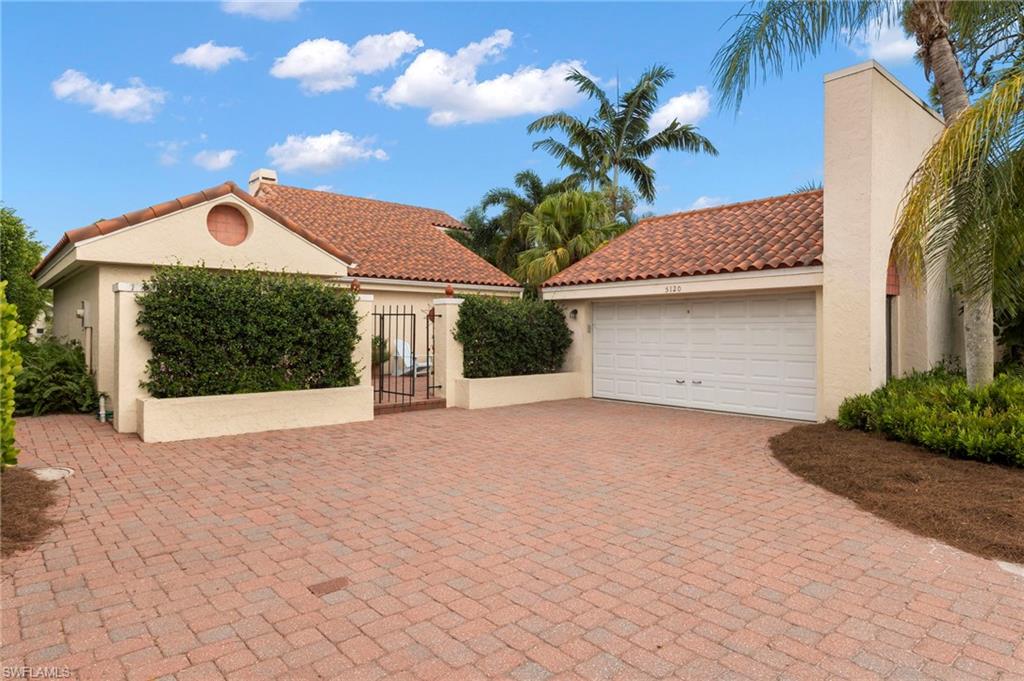 5120 Alpha Court Naples, FL 34105 - Photo 1 of 18 a front view of a house with a yard and garage