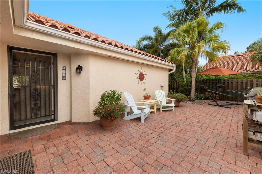 5120 Alpha Court Naples, FL 34105 - Photo 14 of 18 a backyard of a house with barbeque oven table and chairs