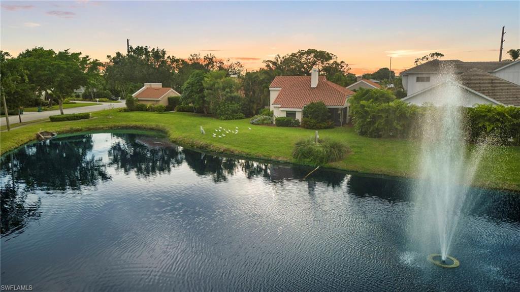 5120 Alpha Court Naples, FL 34105 - Photo 16 of 18 a view of a lake with a yard