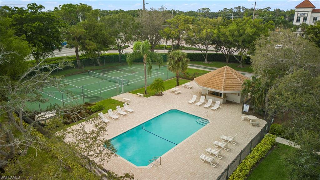 5120 Alpha Court Naples, FL 34105 - Photo 17 of 18 a view of a lake with a house in the background