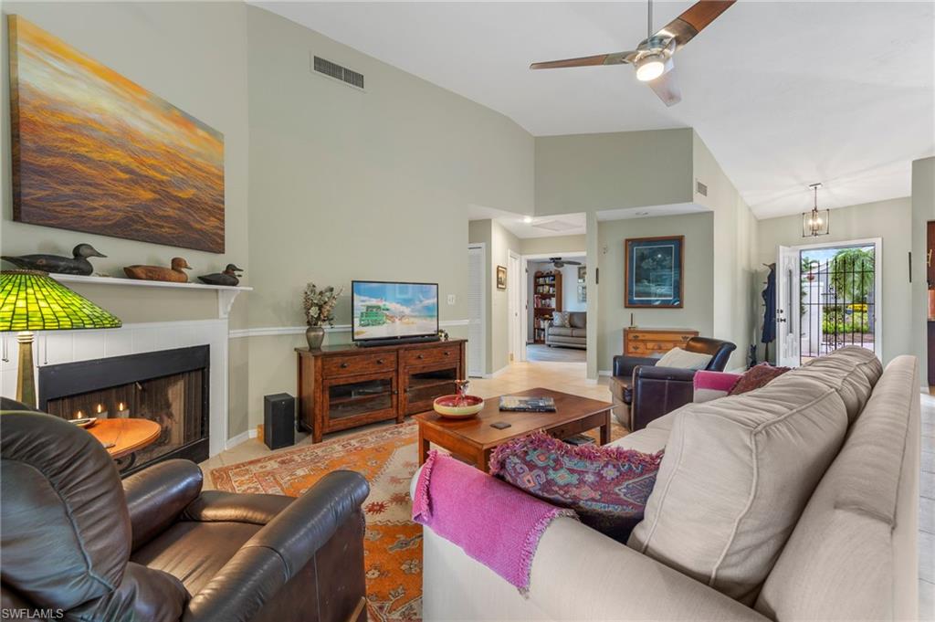 5120 Alpha Court Naples, FL 34105 - Photo 3 of 18 a living room with furniture and a fireplace
