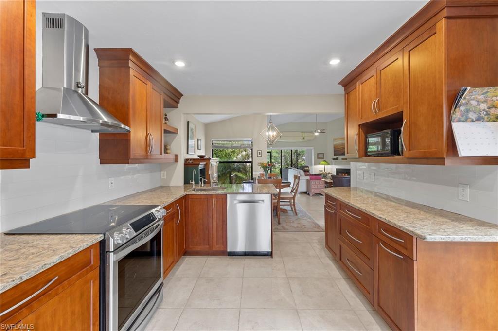5120 Alpha Court Naples, FL 34105 - Photo 4 of 18 a kitchen with a stove a sink and a refrigerator