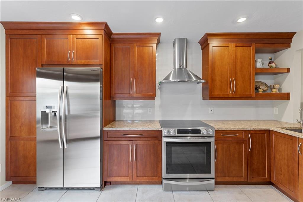 5120 Alpha Court Naples, FL 34105 - Photo 5 of 18 a kitchen with stainless steel appliances granite countertop a refrigerator and a sink
